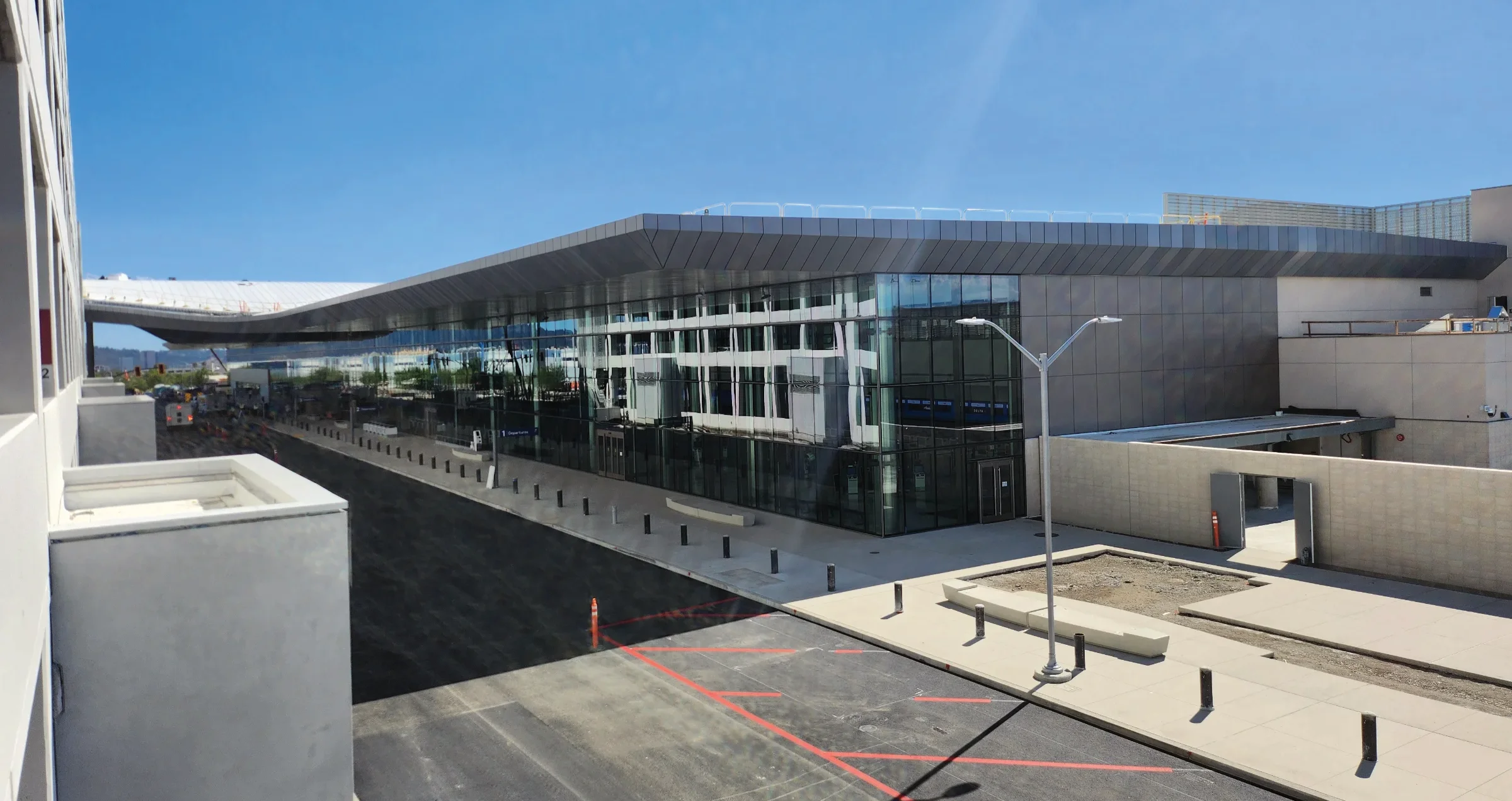 Exterior view of Hollywood Burbank Airport's new terminal, showing its sweeping roofline